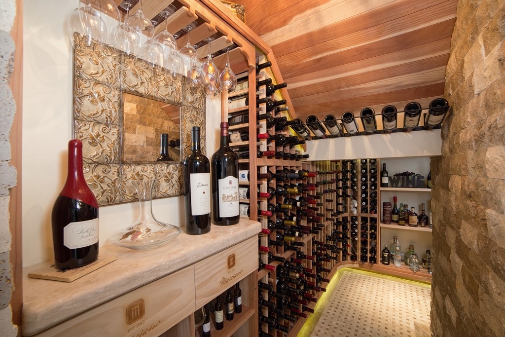 Climate controlled wine cellar constructed in closet located under the stairs. Design & Remodeling by Hochuli